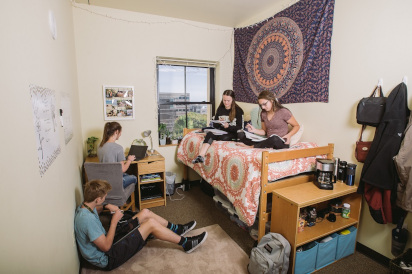 Students studying in a resident's room.