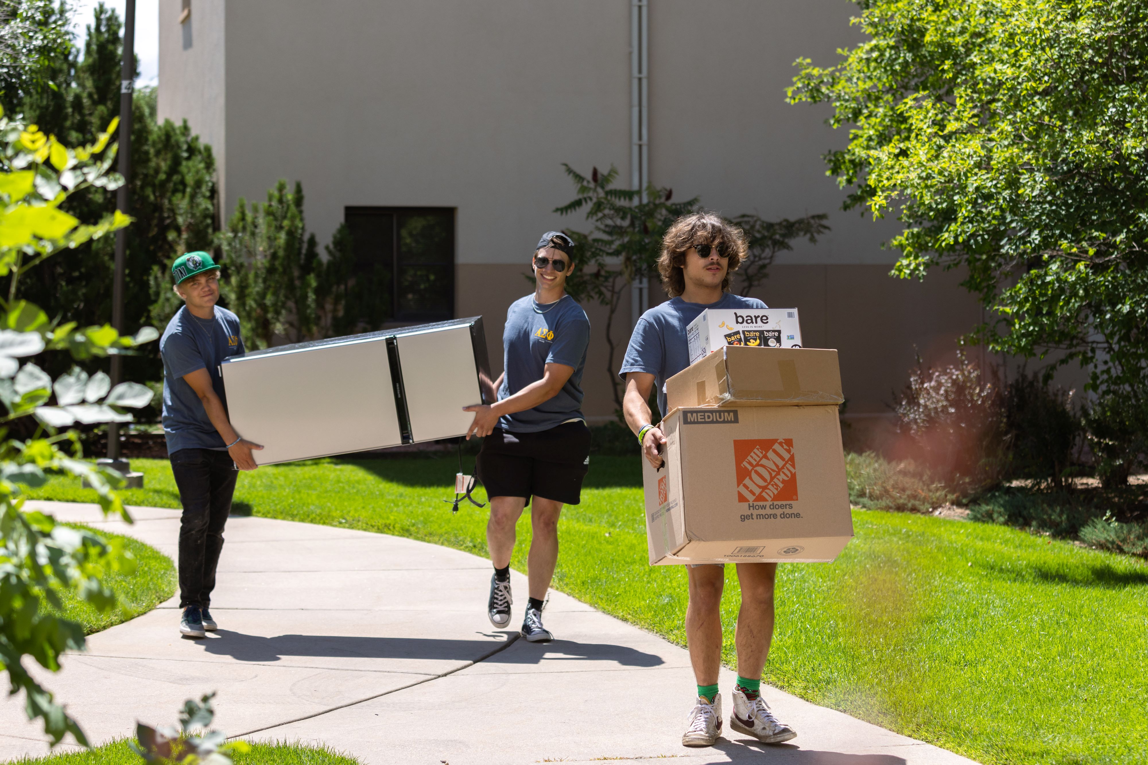 Students helping carry boxes