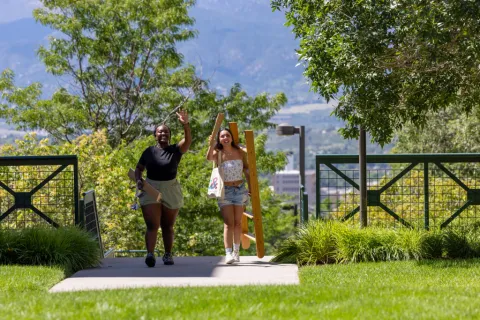 Two students carrying lofting kits for move-in