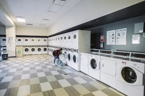 student using the laundry facilities on campus