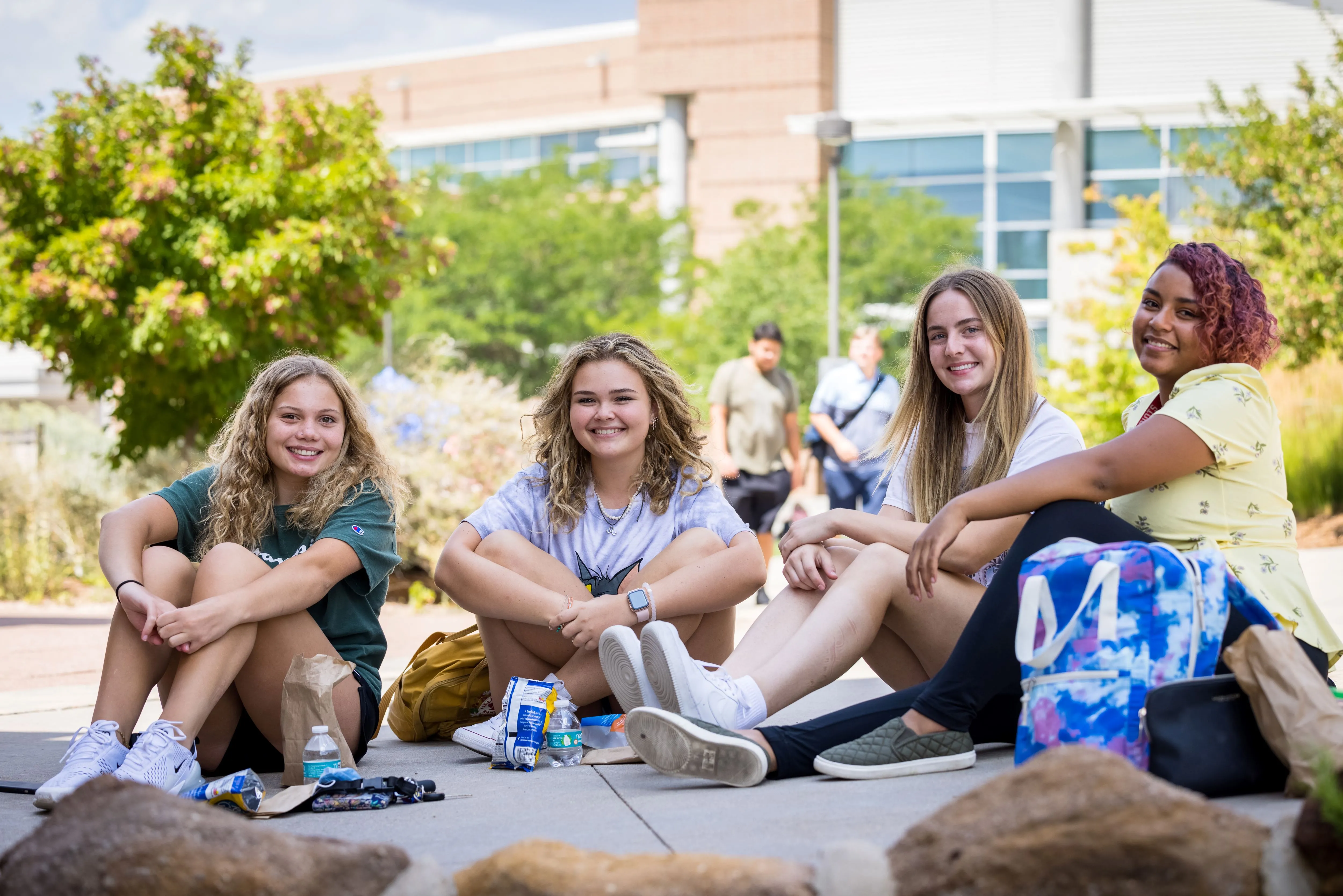 Four students sitting outside