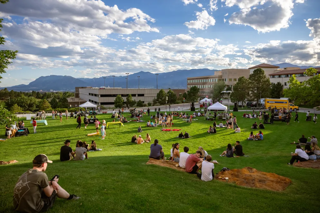Students sitting on the west lawn